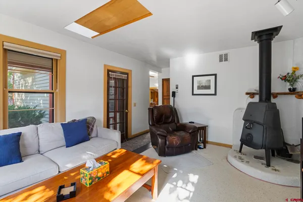 a view of a dining room with furniture and a chandelier