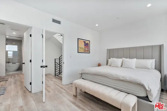 a bedroom with a bed and a couch