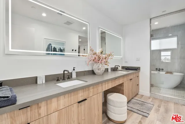 a kitchen with a sink and a large mirror