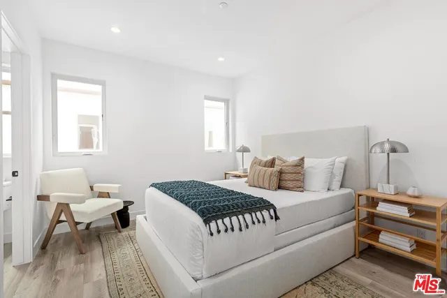 a bedroom with a bed and a couch