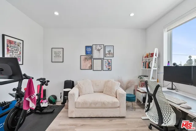 a view of a livingroom with workspace and a couch