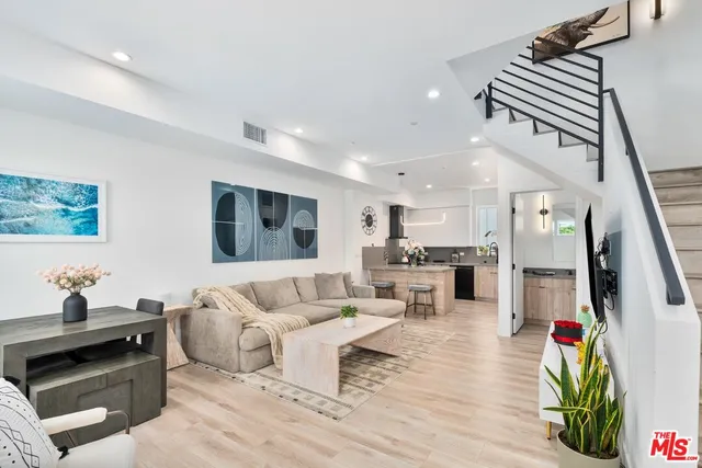 a living room with furniture and kitchen view