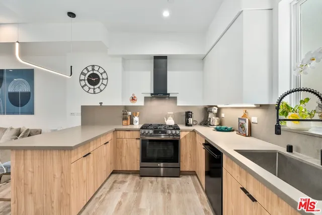 a kitchen with stainless steel appliances a sink stove and cabinets