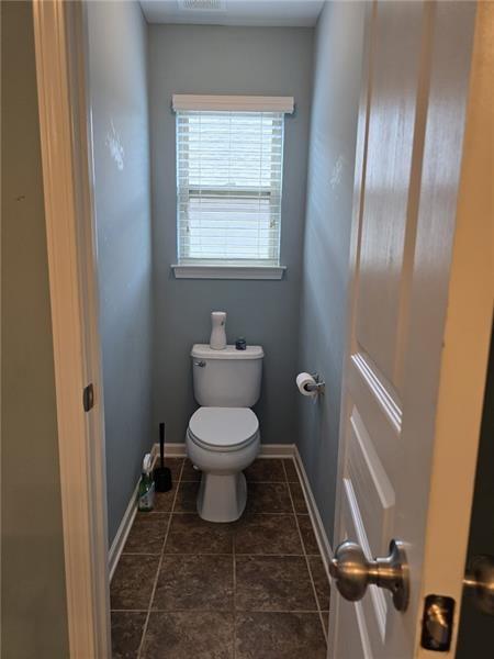 6850 Rocking Horse Lane Cumming, GA 30040 - Photo 16 of 36 a white toilet sitting next to a bathroom sink