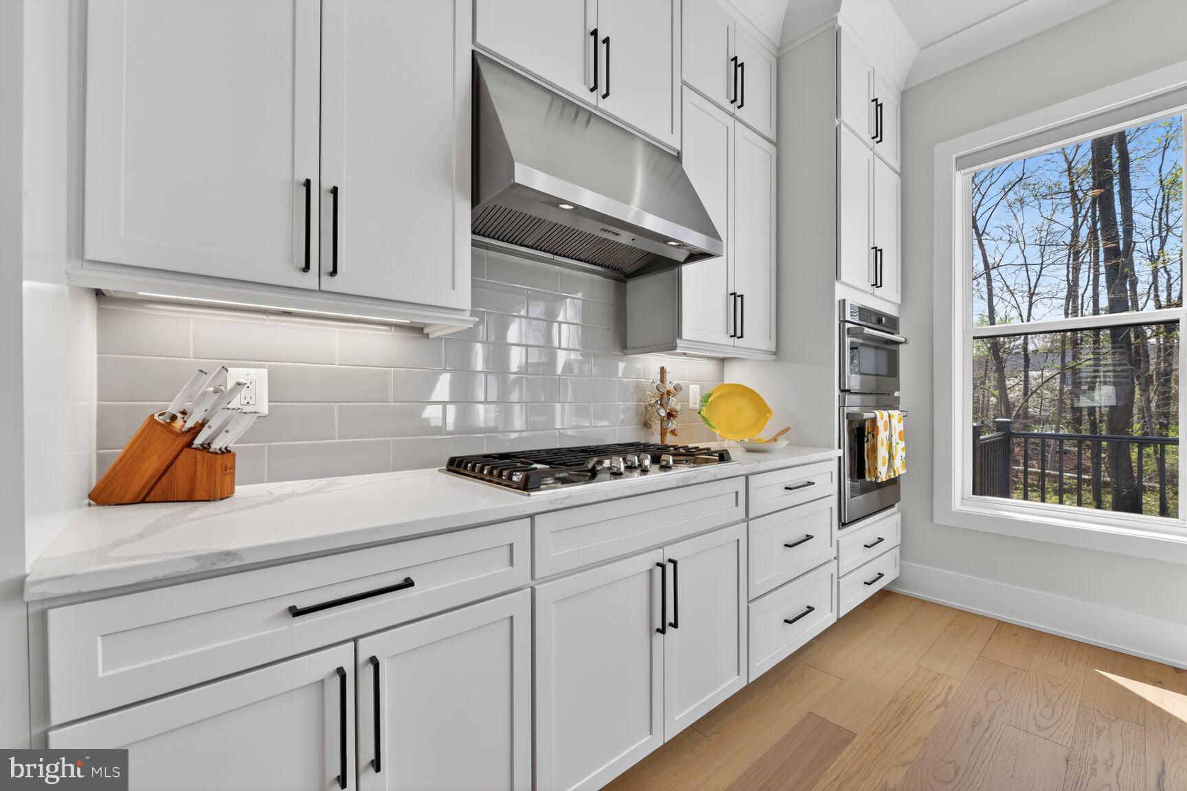 14665 Battery Ridge Lane Centreville, VA 20120 - Photo 13 of 66 a kitchen with stainless steel appliances granite countertop a sink a stove and a wooden floors