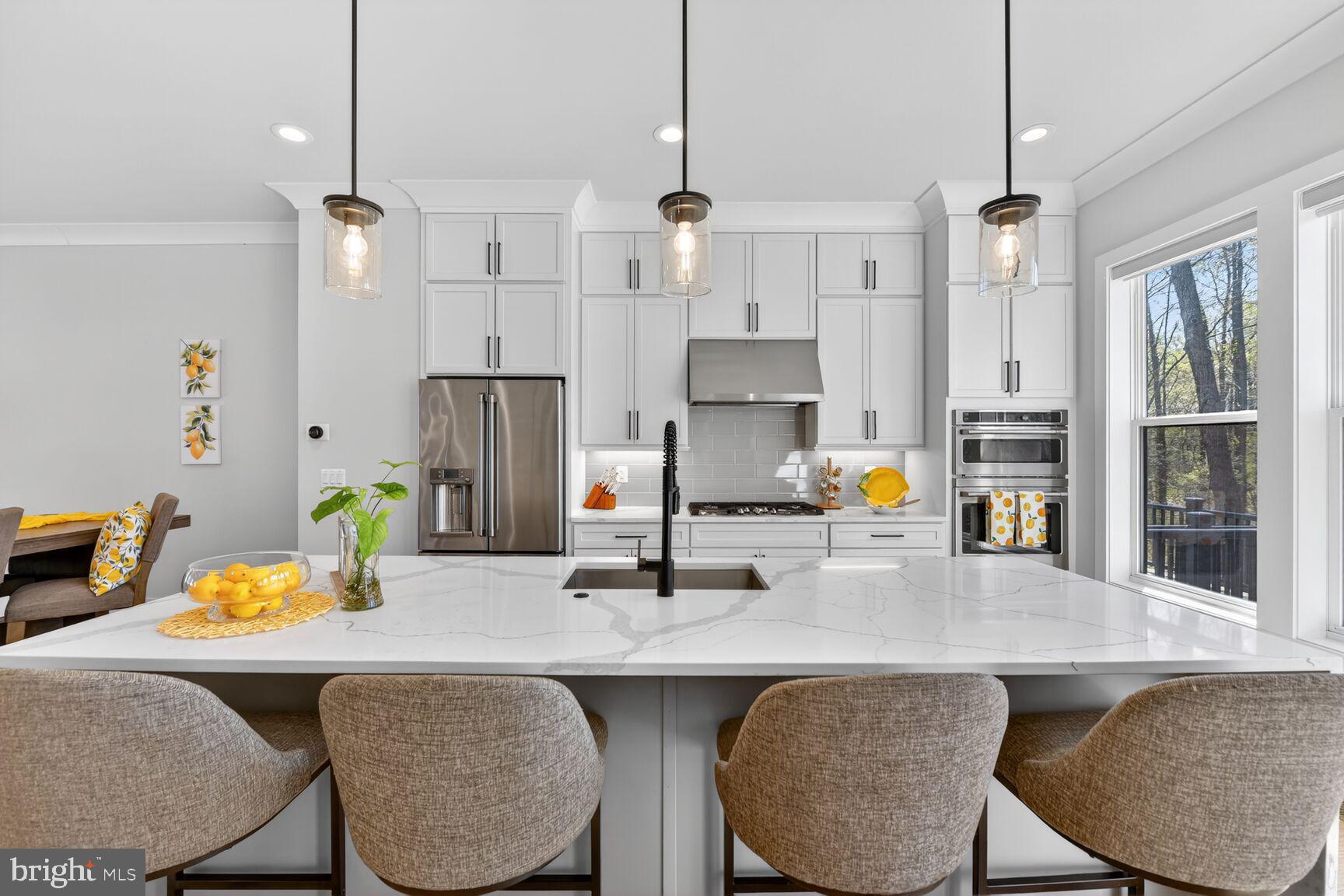 14665 Battery Ridge Lane Centreville, VA 20120 - Photo 15 of 66 a kitchen with stainless steel appliances granite countertop a sink a stove a refrigerator and white cabinets with wooden floor
