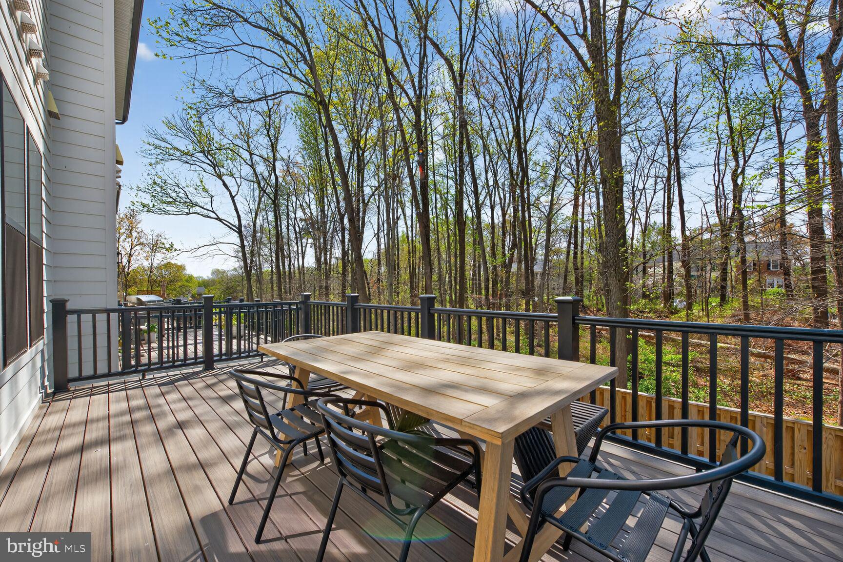 14665 Battery Ridge Lane Centreville, VA 20120 - Photo 24 of 66 a view of a dinning table and chairs on the roof deck