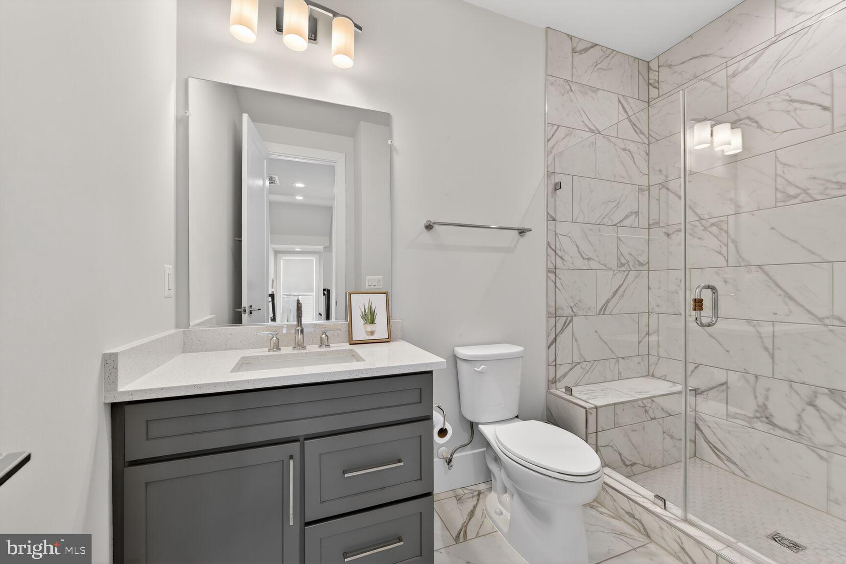 14665 Battery Ridge Lane Centreville, VA 20120 - Photo 36 of 66 a bathroom with a toilet sink vanity and mirror