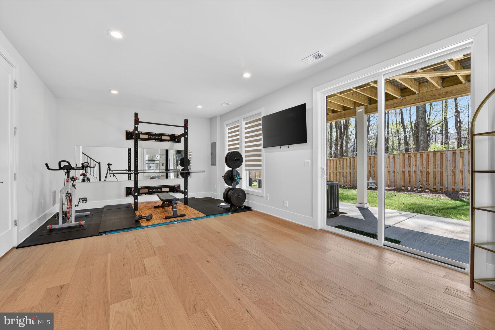 14665 Battery Ridge Lane Centreville, VA 20120 - Photo 45 of 66 a view of a room with gym equipment and floor to ceiling window