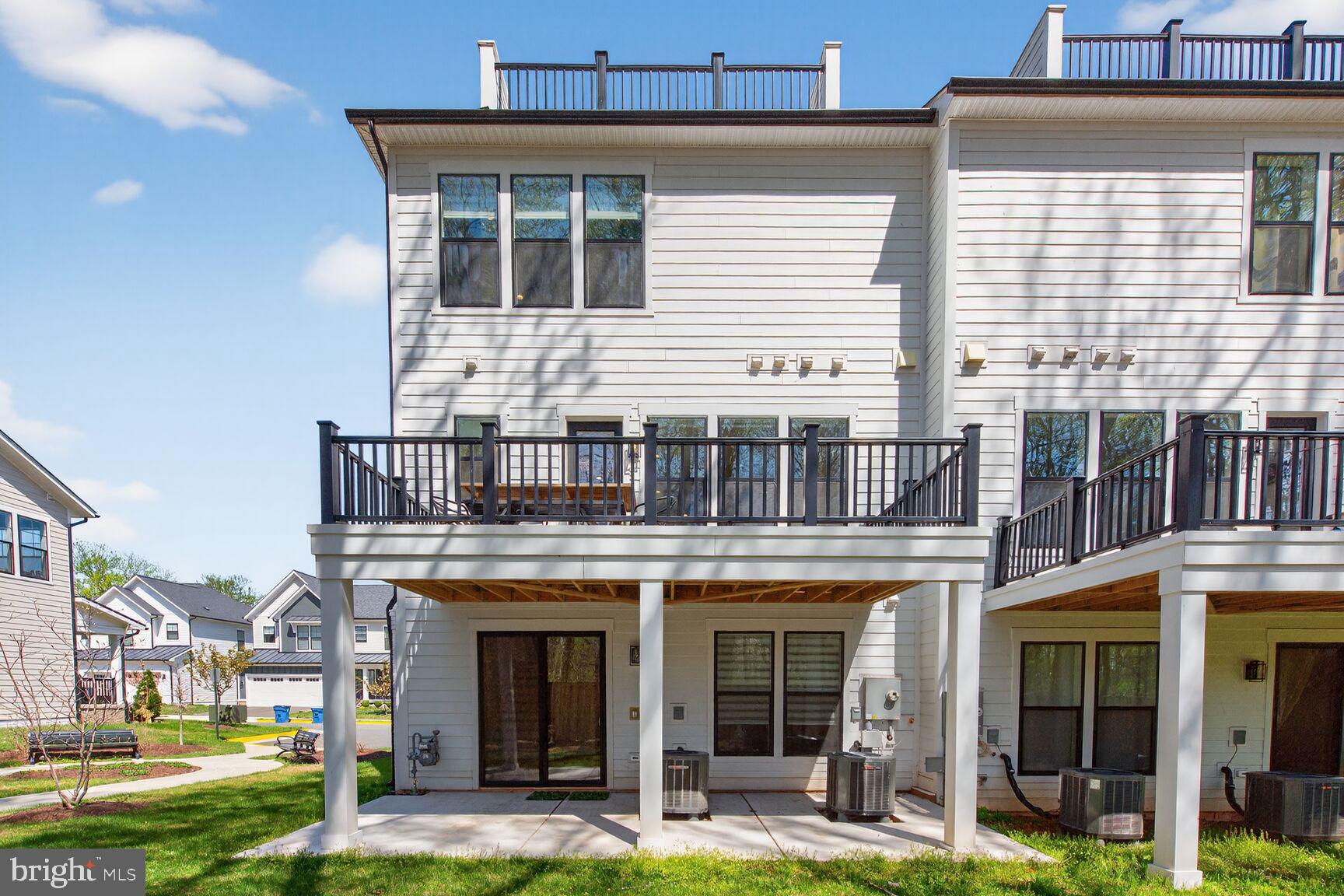 14665 Battery Ridge Lane Centreville, VA 20120 - Photo 52 of 66 a front view of a building with a garden and plants