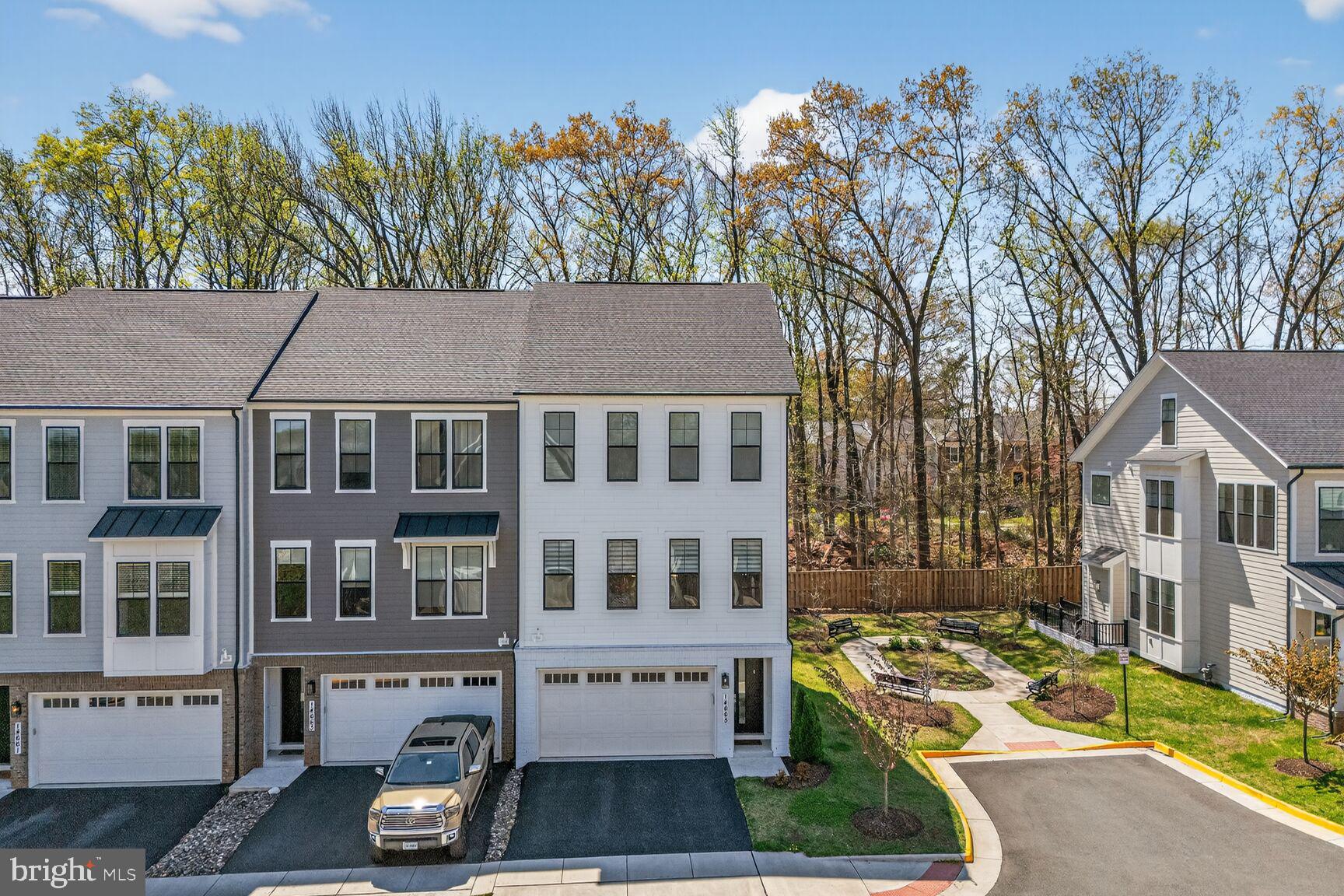 14665 Battery Ridge Lane Centreville, VA 20120 - Photo 58 of 66 a view of a white house next to a yard with large trees