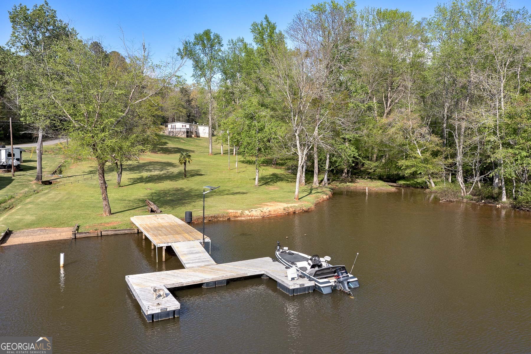 a view of a lake with a lawn chairs