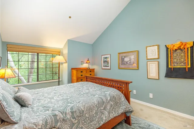 a bed sitting in a bedroom next to a window