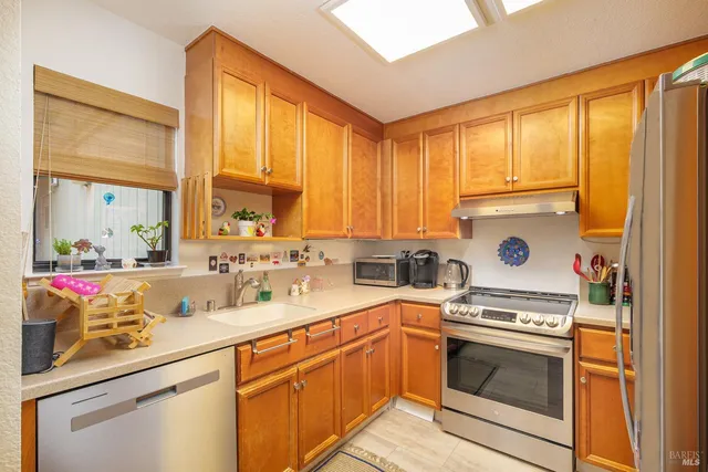 a kitchen with a sink stove top oven and cabinets