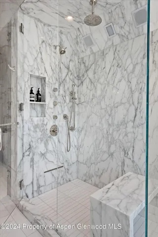 a bedroom with a bed and ceiling fan