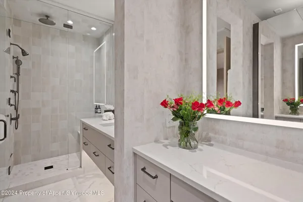 a bathroom with a granite countertop sink a mirror and a toilet