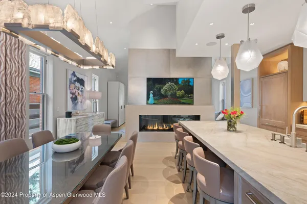 a large kitchen with kitchen island a large counter space a sink and living room view