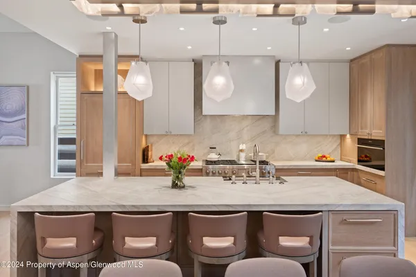 a kitchen with a sink cabinets and wooden floor