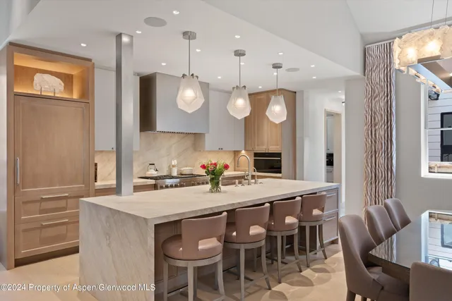 a large kitchen with a table and chairs