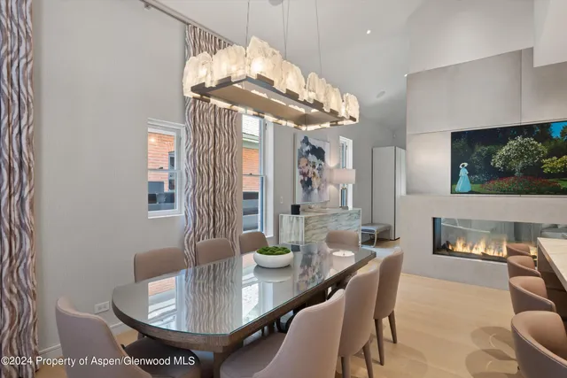 a dining room with furniture a chandelier and window