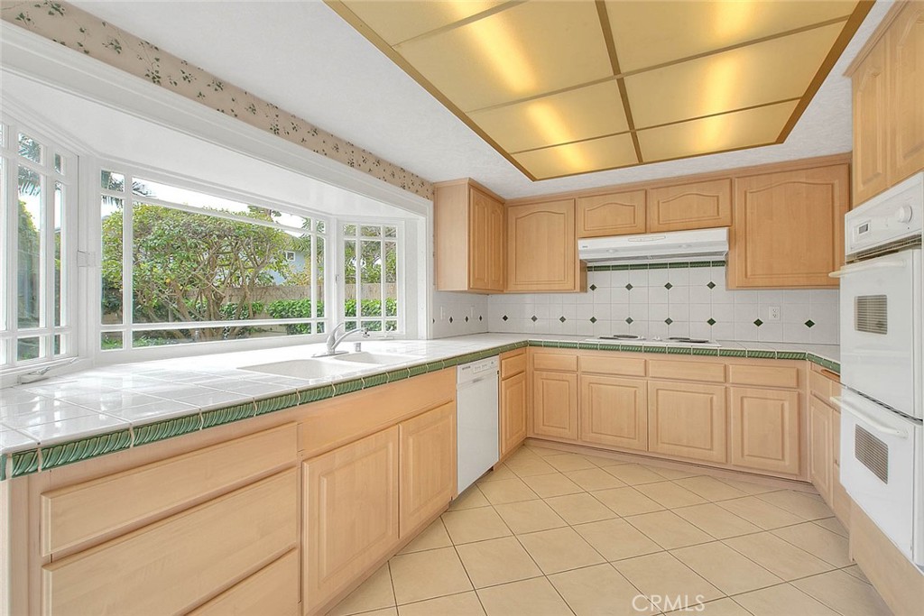 4408 Elder Avenue Seal Beach, CA 90740 - Photo 20 of 73 a large white kitchen with a sink and cabinets