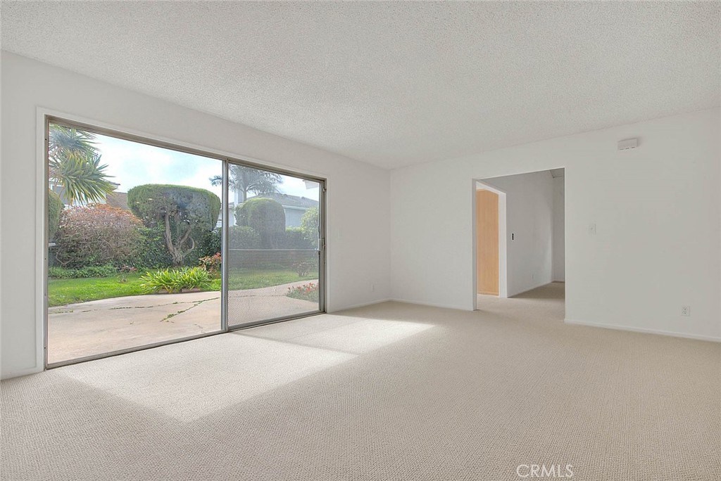 4408 Elder Avenue Seal Beach, CA 90740 - Photo 38 of 73 a view of an empty room with floor to ceiling windows and yard