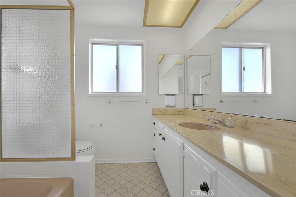 4408 Elder Avenue Seal Beach, CA 90740 - Photo 45 of 73 a bathroom with a granite countertop sink and a mirror