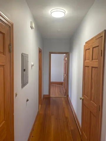 a view of a hallway with wooden floor