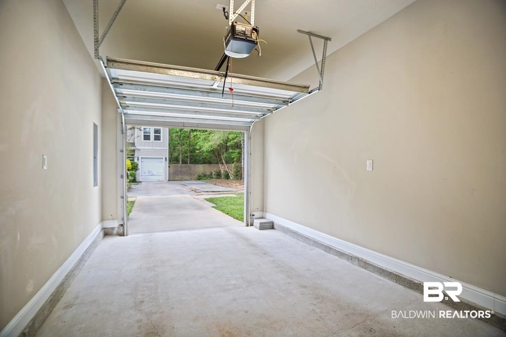 25806 Pollard Road, Unit 27 Daphne, AL 36526 - Photo 41 of 46 Garage featuring baseboards and a garage door opener