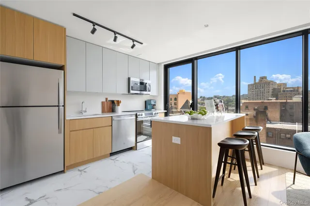 a kitchen with a table chairs refrigerator and cabinets