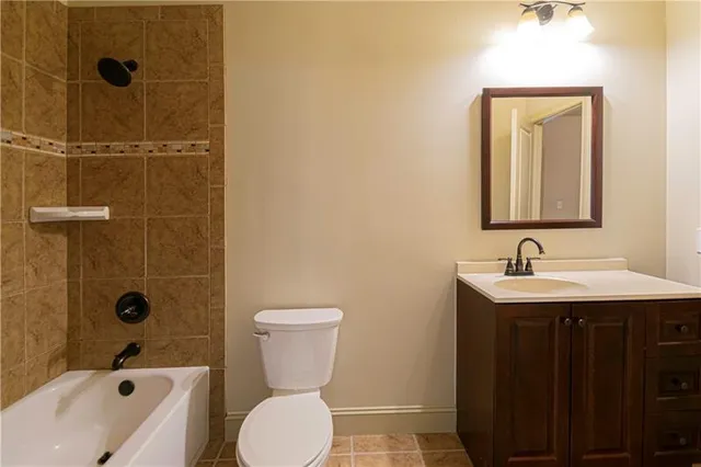 a bathroom with a sink and mirror with toilet