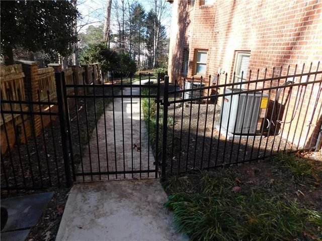 a view of a house with a wooden fence