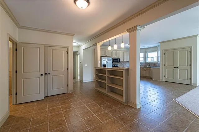 a view of a hallway with wooden shelves