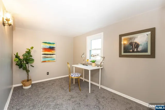 a view of a workspace with furniture and a potted plant