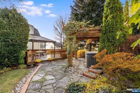 a view of a city with flower plants and large trees