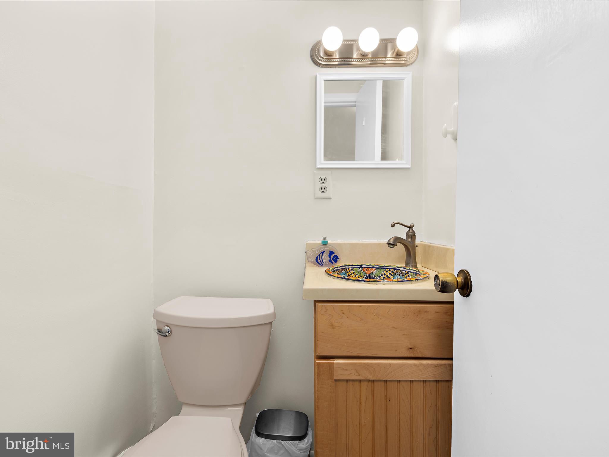 593 Riverside Drive Pasadena, MD 21122 - Photo 13 of 56 a white toilet sitting next to a bathroom sink