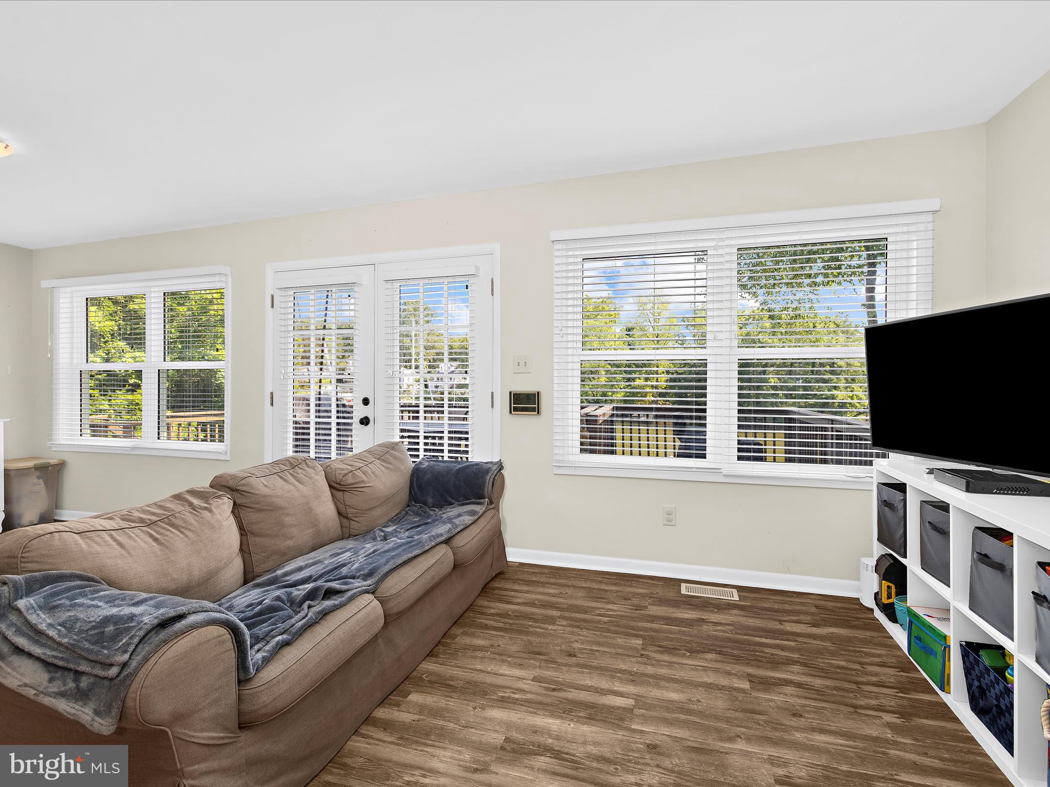 593 Riverside Drive Pasadena, MD 21122 - Photo 14 of 56 a living room with furniture flat screen tv and a large window