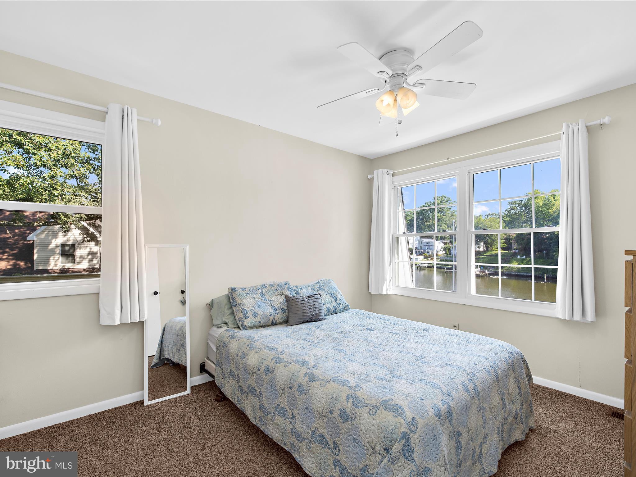 593 Riverside Drive Pasadena, MD 21122 - Photo 20 of 56 a bedroom with a large bed and a window