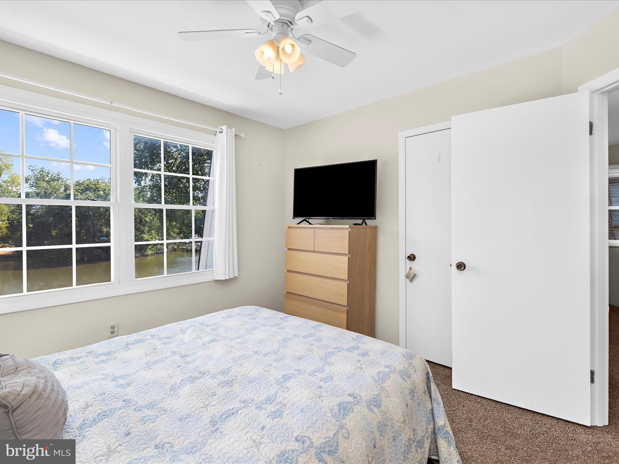 593 Riverside Drive Pasadena, MD 21122 - Photo 21 of 56 a bedroom with a bed and a flat screen tv