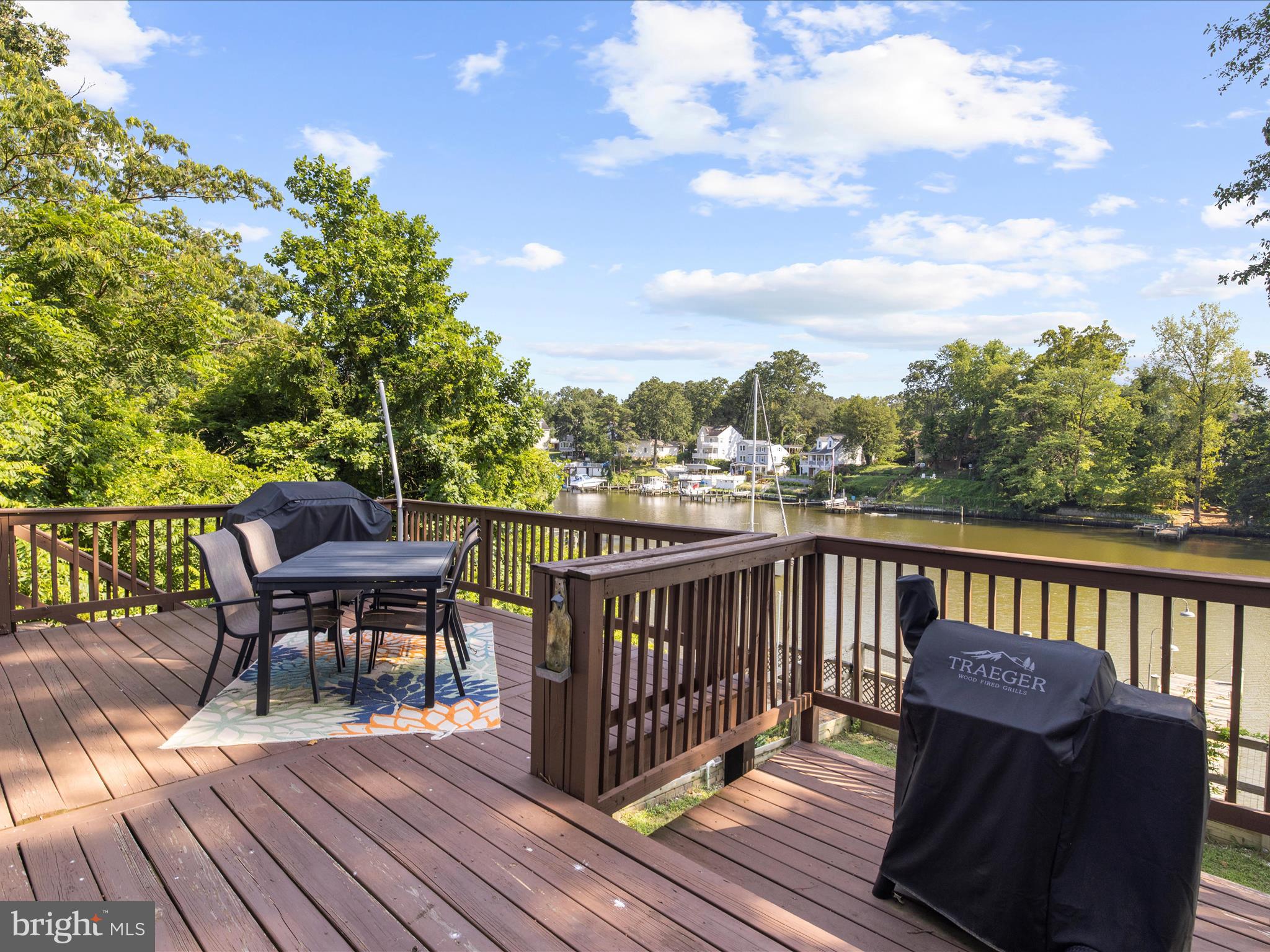593 Riverside Drive Pasadena, MD 21122 - Photo 25 of 56 a view of a deck with wooden floor and outdoor seating
