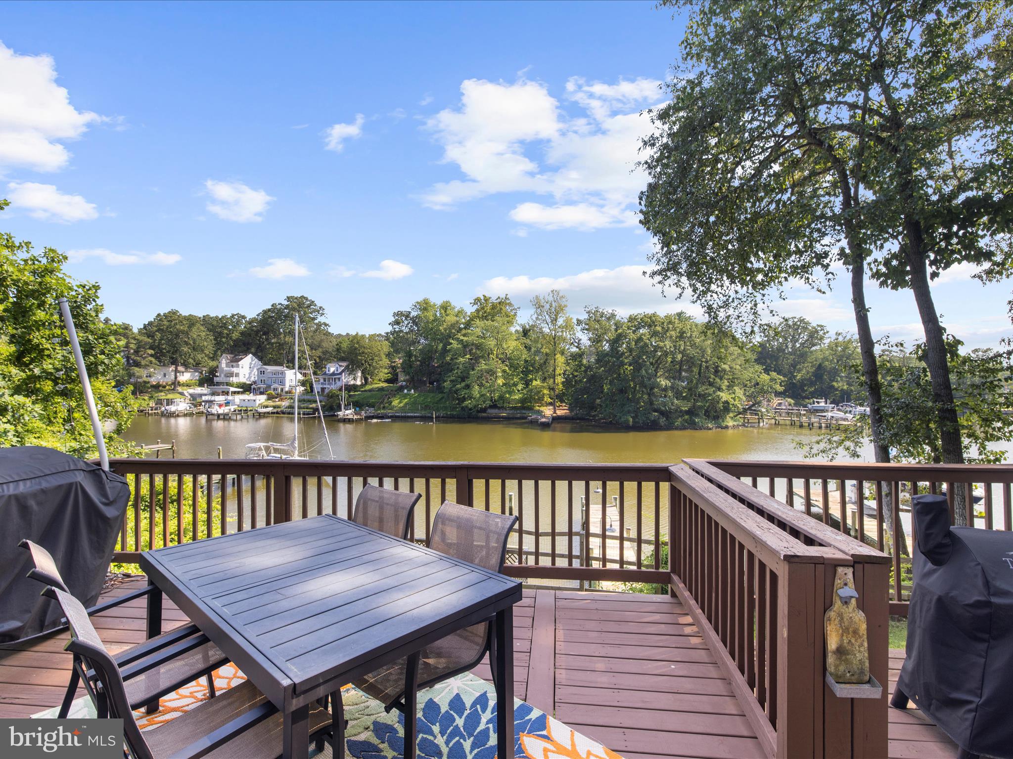 593 Riverside Drive Pasadena, MD 21122 - Photo 28 of 56 a wooden deck with sunset view