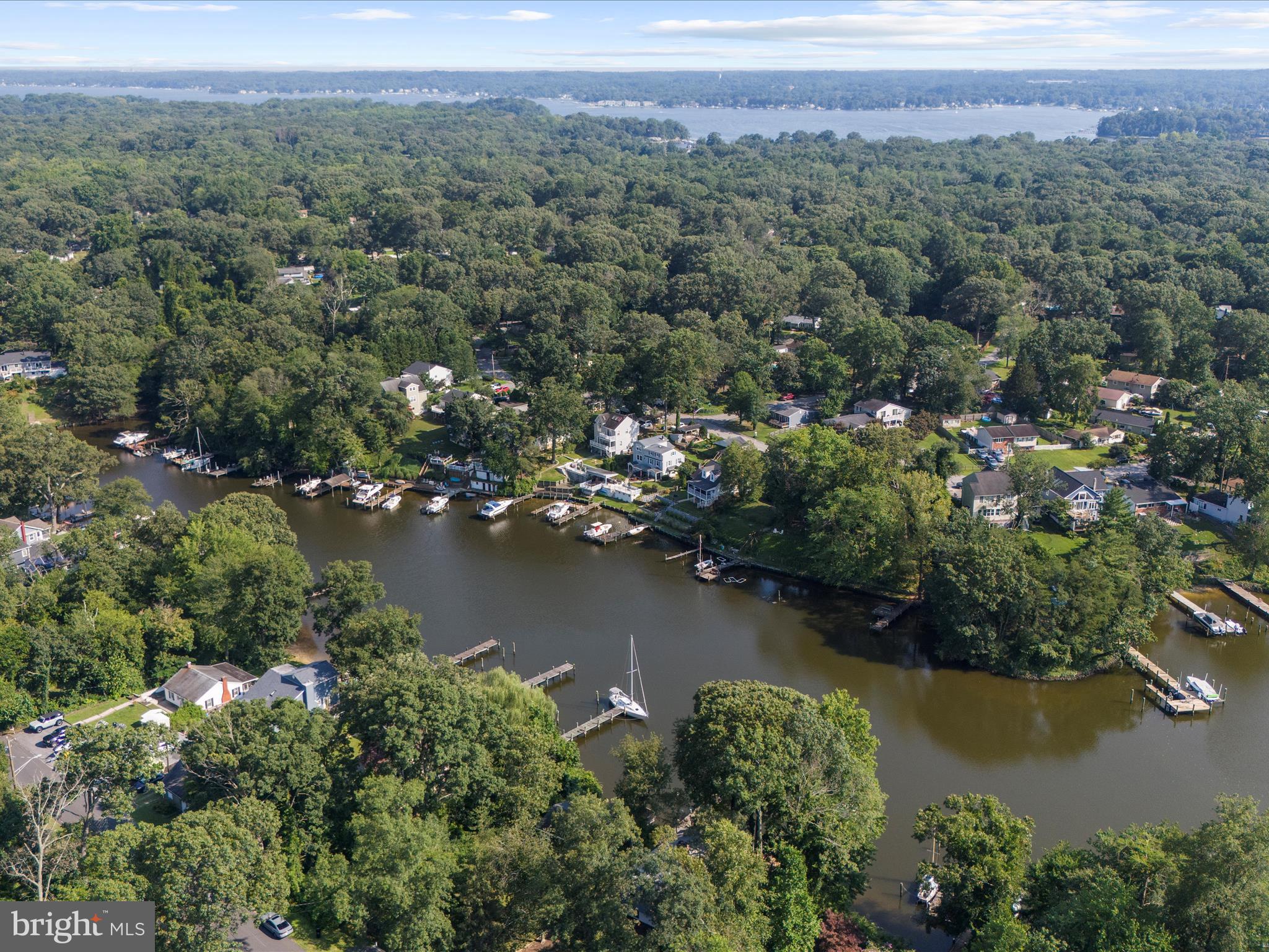593 Riverside Drive Pasadena, MD 21122 - Photo 38 of 56 an aerial view of a houses with a lake view