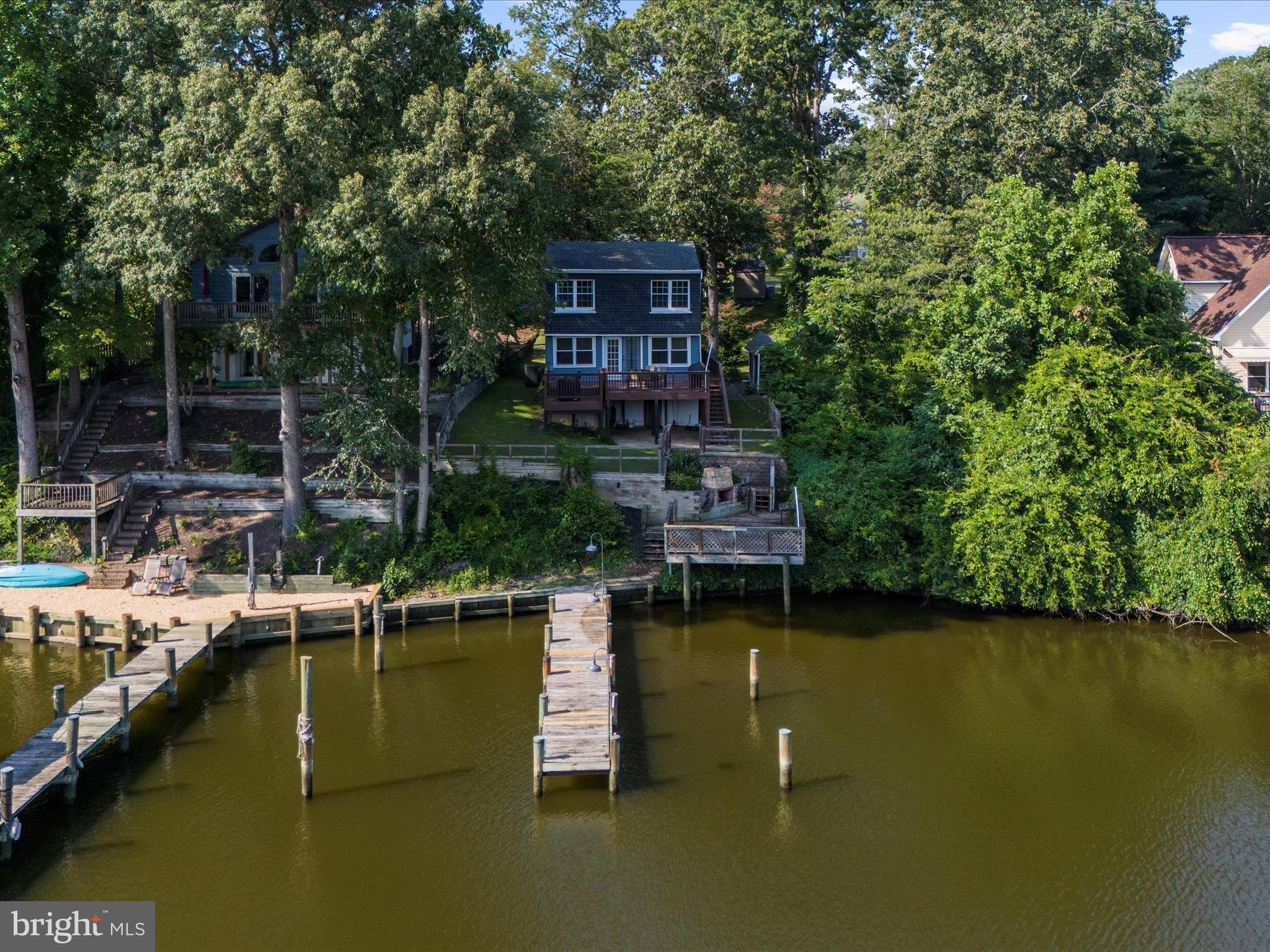 593 Riverside Drive Pasadena, MD 21122 - Photo 45 of 56 a view of a lake with a house in the background