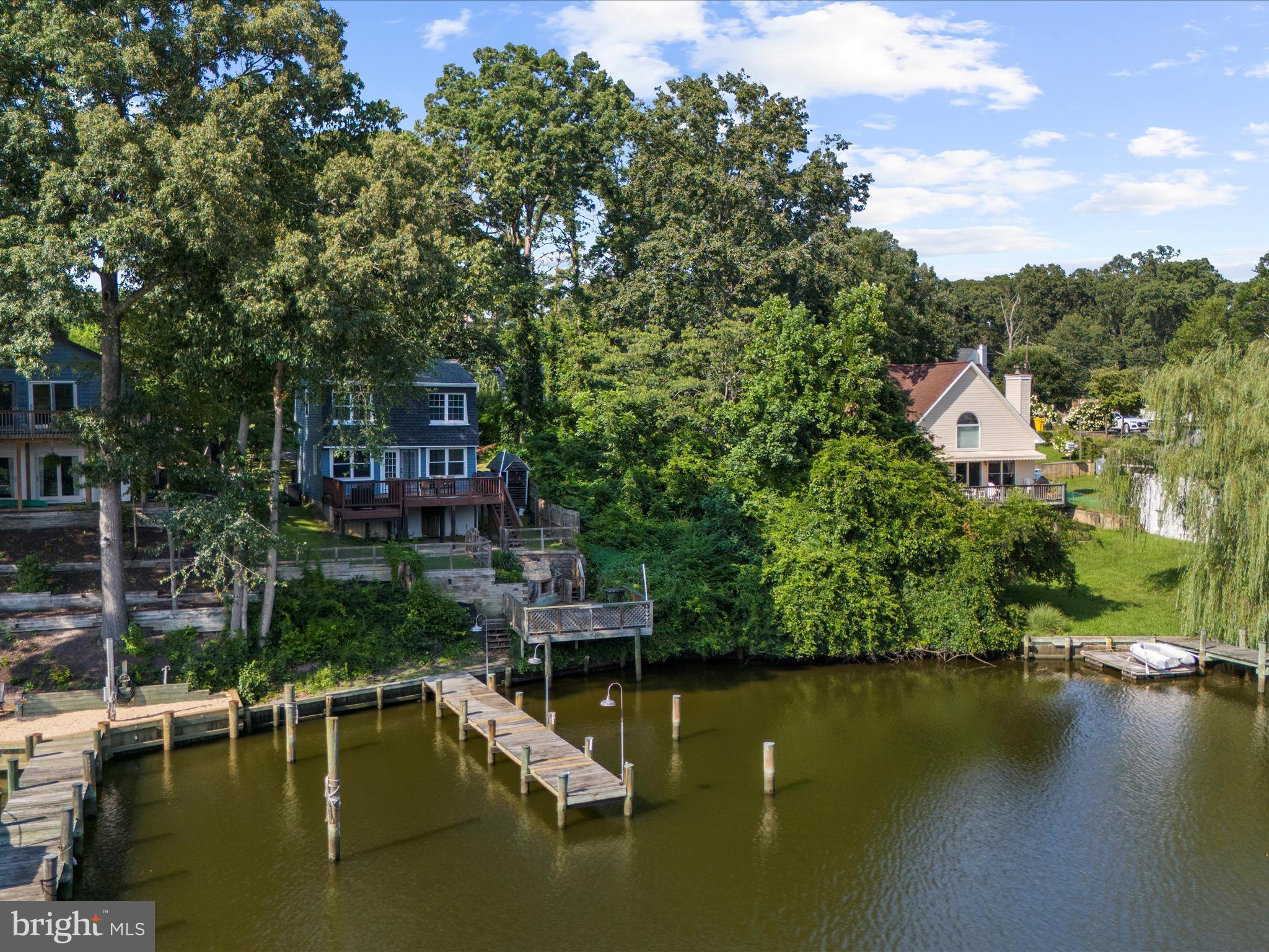 593 Riverside Drive Pasadena, MD 21122 - Photo 46 of 56 a view of a lake with a house in the background