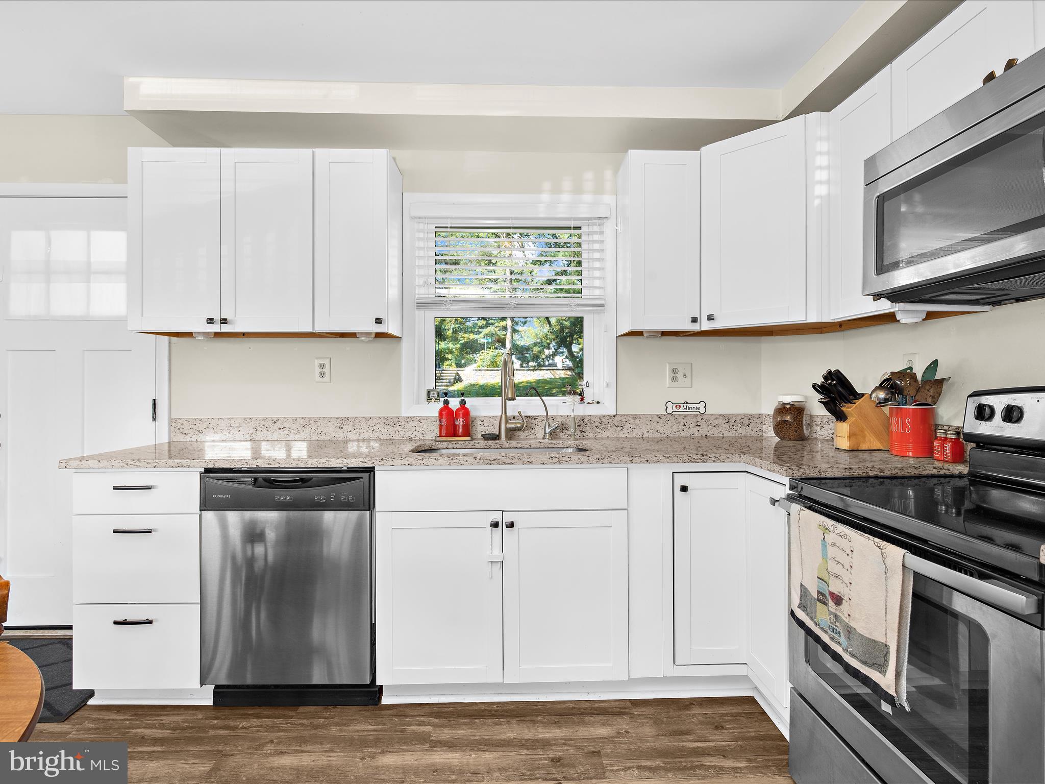 593 Riverside Drive Pasadena, MD 21122 - Photo 9 of 56 a kitchen with granite countertop white cabinets stainless steel appliances and a window