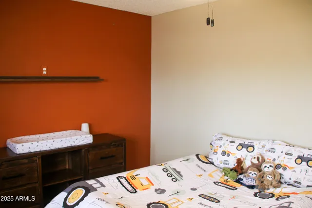 a bedroom with a bed and a table in it