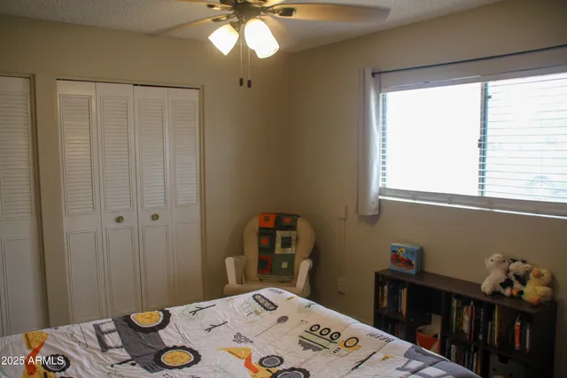 a bedroom with a bed and a table in it