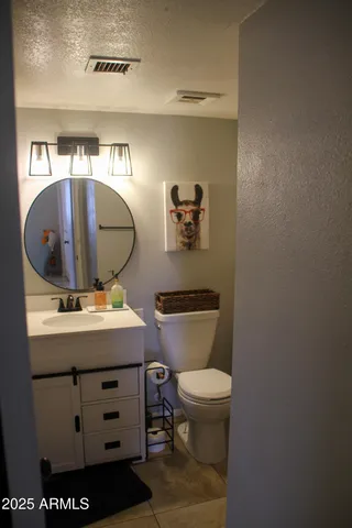 a bathroom with a toilet a sink and mirror