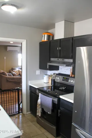 a kitchen with stainless steel appliances a stove a refrigerator and a sink
