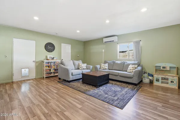 a living room with furniture and wooden floor